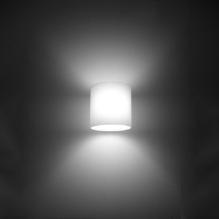 Cylindrical frosted shade of the VICI lamp glowing brightly, highlighting the up and down light wash.