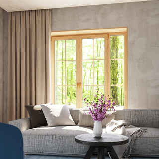 Neutral living room setting with textured grey walls, wooden window frame, and soft furnishings.