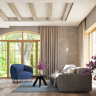 VICI wall lamp mounted on a textured wall in a living room with wooden beams and large windows.