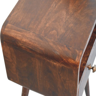 Rich dark walnut finish detail on the curved corner of the bedside table top.