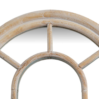 Close-up detail of the washed wood texture on the arched frame and window bars.