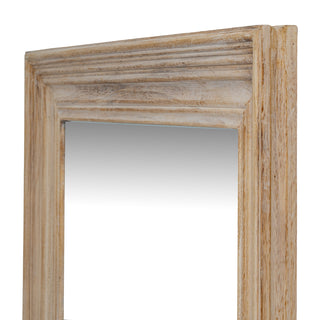 Detail of the mirror frame viewed from the side, showing the stepped profile and the deep, textured grain of the light wood.