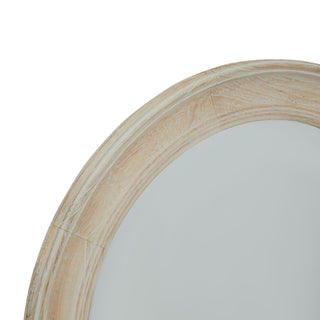 Close detail of the washed wood frame texture and grain on the round mirror.