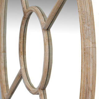 Angled close-up showing the light washed wood texture and construction detail of the round mirror frame.