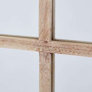 Close-up showing the textured washed wood grain and the joint of the mirror's dividing bars.