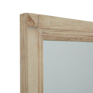 Washed wood texture and corner joint detail of the rectangular mirror frame.