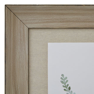 Close-up of the light wood frame texture, mitred corner, and beige textured mount.
