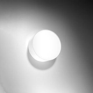 White cylindrical ceiling light fixture illuminated, highlighting the side profile and glow.