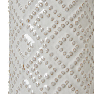 Close-up detail of the white ceramic lamp base showing the raised beaded diamond pattern and glossy glaze.