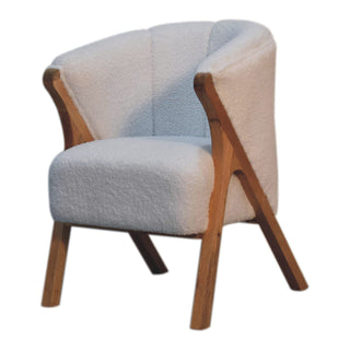 Minimalistic white boucle chair highlighting the angled wooden A-frame structure and textured upholstery.