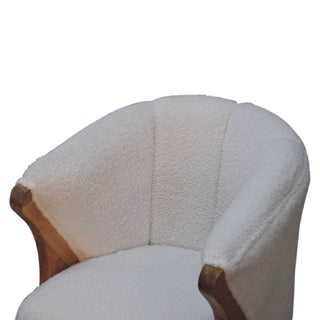 Close-up of the white boucle seat and curved backrest showing the exposed wooden arm frame.