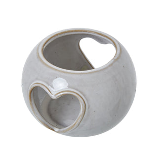 Angled view of the grey-white ceramic holder showing the top tealight opening and the front heart aperture.