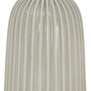 Close-up detail of the vertical ribbed texture on the speckled white ceramic vase.