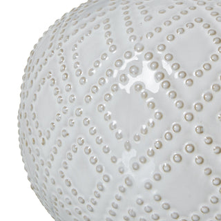Close detail of the glossy white ceramic base showing the raised dot texture arranged in a diamond pattern.