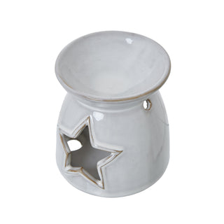 Angled view showing the deep wax melt bowl, star cut-out opening, and small ventilation hole.