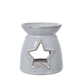 Full view of the white ceramic tealight holder with a central star cut-out.