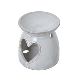 White ceramic wax melt burner with a heart-shaped cut-out and a shallow bowl on top.