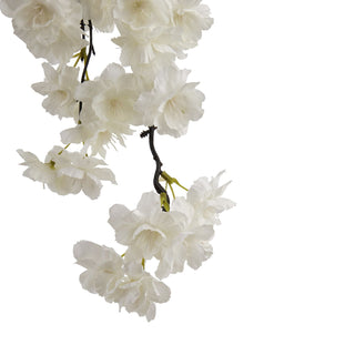 Close-up detail of the artificial white cherry blossom petals and dark brown twig structure.