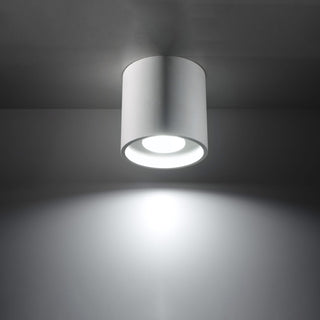 White cylindrical ceiling lamp fixture shown illuminated, casting a bright circular spotlight downwards.
