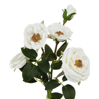 Close-up detail of the white artificial rose blooms showing textured petals and brown/gold stamens.