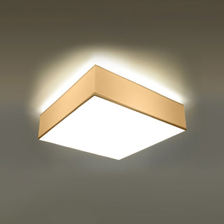 Angled view of the square ceiling lamp illuminated, showing the warm light spilling onto the ceiling.