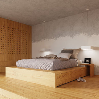 Pair of white square lamps suspended as bedside lighting in a minimalist bedroom setting.
