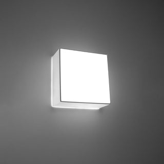 Angled view of the illuminated square lamp, highlighting the bright face and strong light spill.