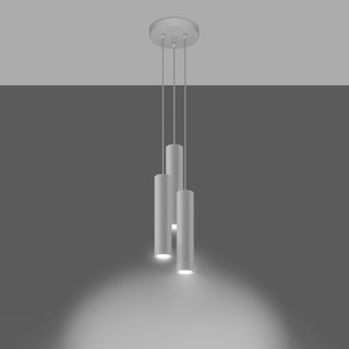 Three white cylindrical pendants switched on, casting light downwards onto a surface.