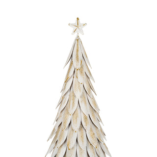 Close detail of the white metal tree's leaf branches with distressed gold veining, topped by a star.