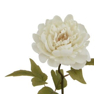 Close-up detail of the layered creamy white artificial peony bloom and textured green leaves.