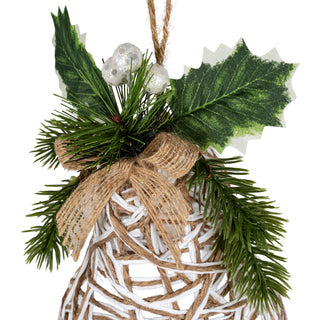 Detail shot showing the jute bow, faux holly leaves, glitter berries, and woven white rattan texture.