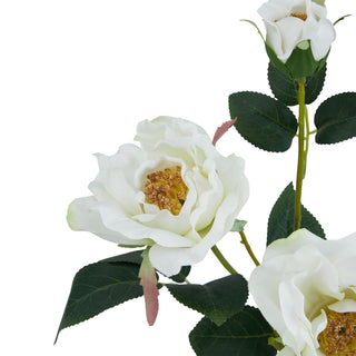 Close-up of an open artificial white tea rose flower face with detailed petals and golden yellow stamens.