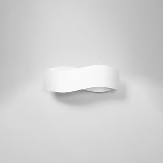 White curved wall light fixture with a decorative wave shape, shown front-on against a plain wall.