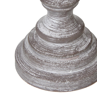 Close-up of the turned, stepped foot of the lamp base showing the distressed white paint finish.