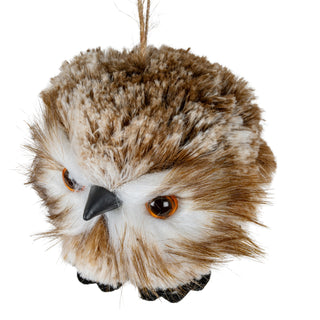 Angled view of the decorative owl's face, highlighting the amber eyes and pointed black beak.