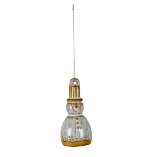 Front view of the glazed ceramic snowman ornament hanging on a chain. White and brown mottled finish.