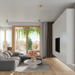 Modern living room with light wood floors, grey sofa, and patio doors. Three matching wooden globe lights are mounted on the ceiling.