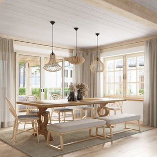 Three wooden pendant lamps, two Elza style and one rounded design, hanging over a light wood dining table.