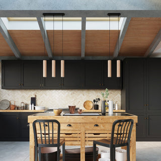 Two twin wooden pendant sets over a kitchen island in a modern kitchen with black cabinets.
