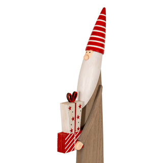 Side view of the wooden elf showing the raw wood grain body and the stacked Christmas presents.