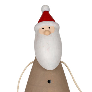 Close-up of the wooden Santa's painted face, white beard, red hat, and conical brown body.