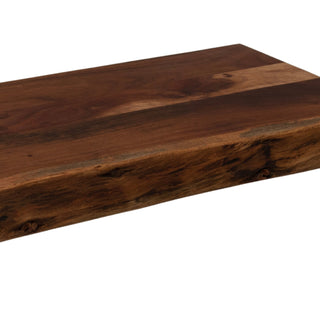 Close up of the dark brown wood grain and thick side profile showing the natural, rough live edge.