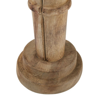 Detail shot of the stacked circular wooden base of the nutcracker ornament, highlighting the natural wood grain.
