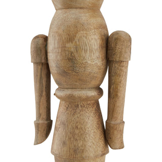 Close detail of the nutcracker ornament's turned wooden body, arms, and natural wood grain texture.