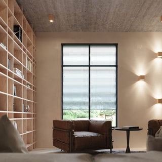 Wooden quad lights used as ceiling spots and wall uplighters in a modern library with timber shelving.