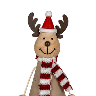 Close-up of the wooden reindeer's face, wearing a Santa hat and red and white striped knitted scarf.