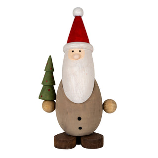 Plain front shot of a wooden Santa figure with a red hat, holding a small green Christmas tree with red dots.