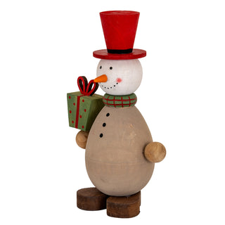 Angled view of the wooden snowman decoration, highlighting the painted face, checked scarf, and natural wood body.