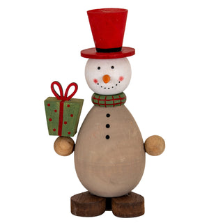 Wooden snowman decoration wearing a red top hat and scarf, holding a green gift box.