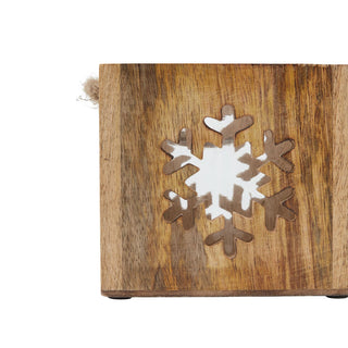 Close detail of the wooden tealight holder, showing the wood grain and the carved snowflake shape.